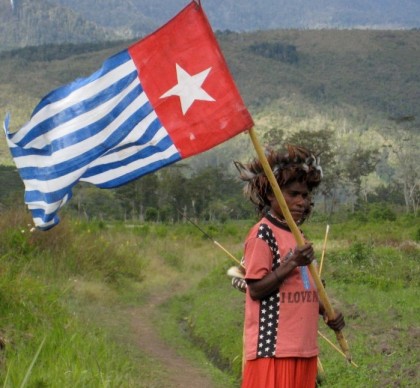 A woman waving the West Papuan flag. Photo: www.yorkvision.co.uk.