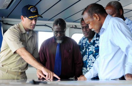 Richard Namo Irosaea, centre from left being shown a map of US Navy vessel. Photo credit: www.msc.navy.mil.