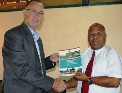 Australian High Commissioner to Solomon Islands Andrew Byrne handing over the Timber Guideline to Forestry PS Barnabas Anga. Photo credit: Rosalie Nongebatu.