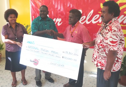 Our Telekom's Loely Ngira handing the cheque to Tourism Director Barney Sivoro. Photo credit: SIBC.