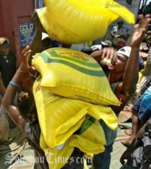 Bags of rice being loaded onto a vessel. Photo credit: Solomon Times online.