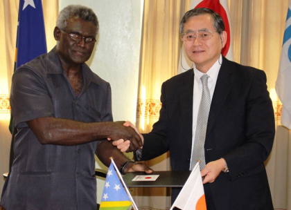 A handshake of friendship between Solomon Islands and Japan by PM Sogavare and Ambassador Kimiya after sealing the agreement for the Kukum Highway Project. Photo credit: OPMC.