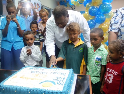 CBSI Governor Denton Rarawa helping to cut the cake to mark the launching. Photo credit: SIBC.
