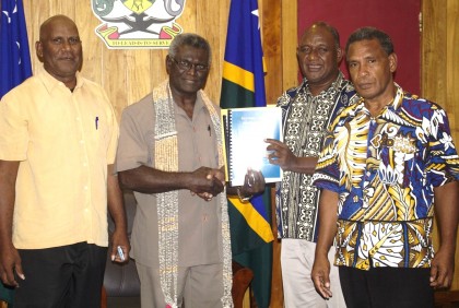 Fiu Hydro Chairman Alfred Gegeo hands over the strategic plan to PM Sogavare as two members look on. Photo credit: OPMC.