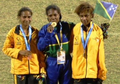 Sharon Firisua who took gold in the women's 5,000 metres, celebrating with PNG athletes. Photo credit: www.insidethegames.biz