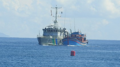 The blue boats being escorted into Honiara earlier this month... 