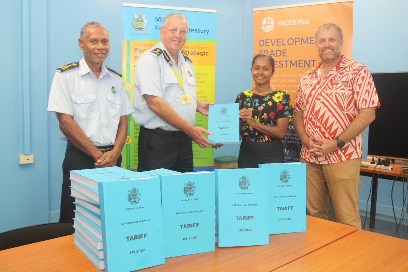 MFAET hands over printed copies of Harmonized System 2022 edition to Customs and Excise Division.